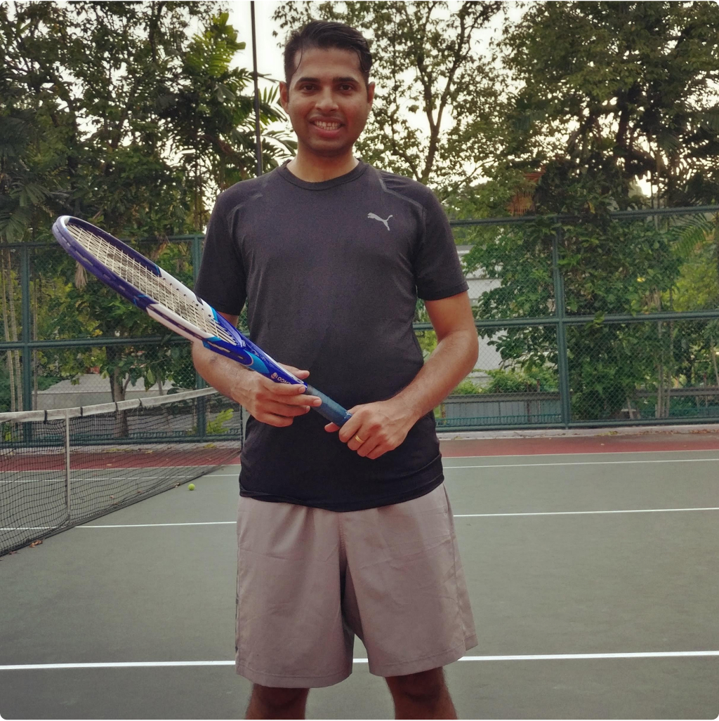 Photo of Sagar holding a tennis racket